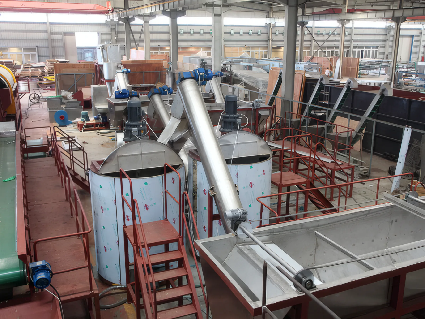 Hot washing vessels with screw loaders and rinse tank, elevated view
