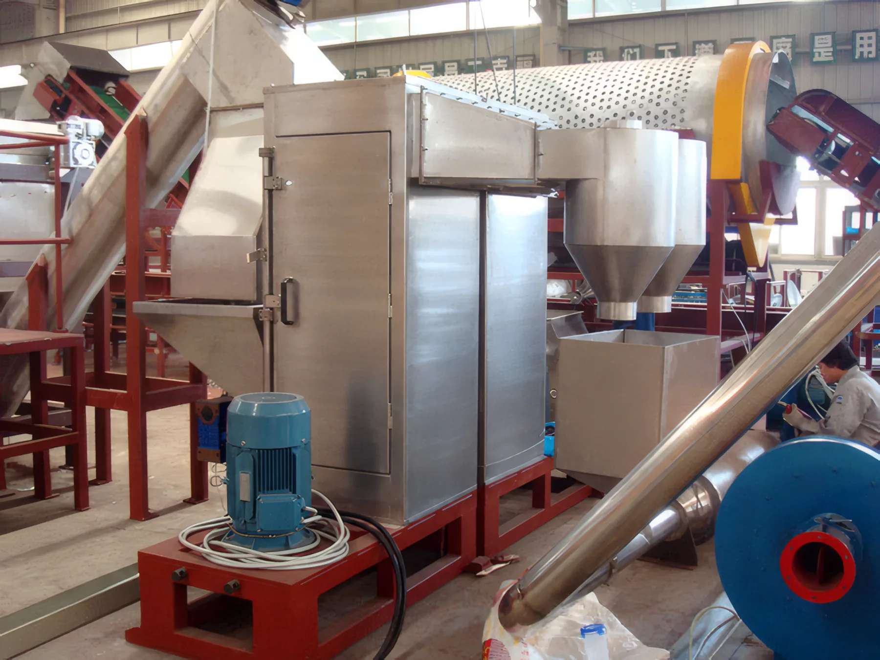 Stainless separator cabinet and blue blower in front of the trommel