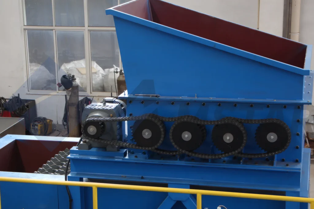 Debaler Machine (2018 Model) – exposed chain drive beneath the feed hopper